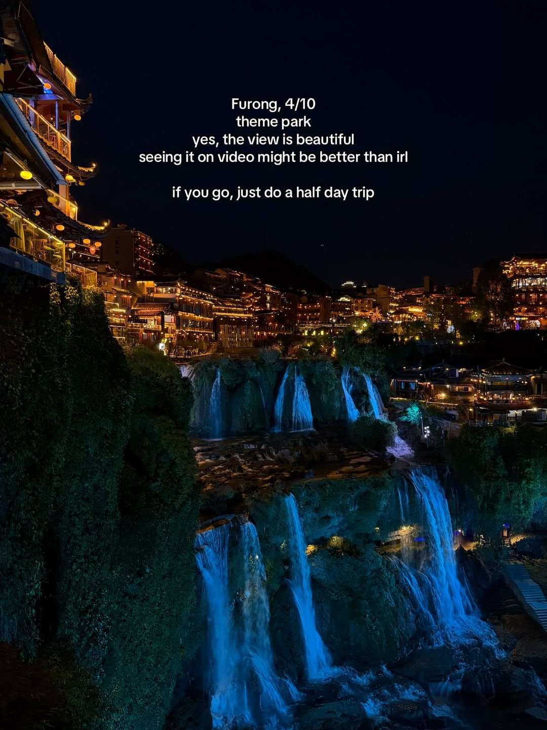 Furong Town and its waterfall illuminated after dark
