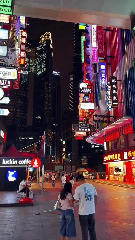 Pedestrians beneath vertical restaurant signs near Deyi World