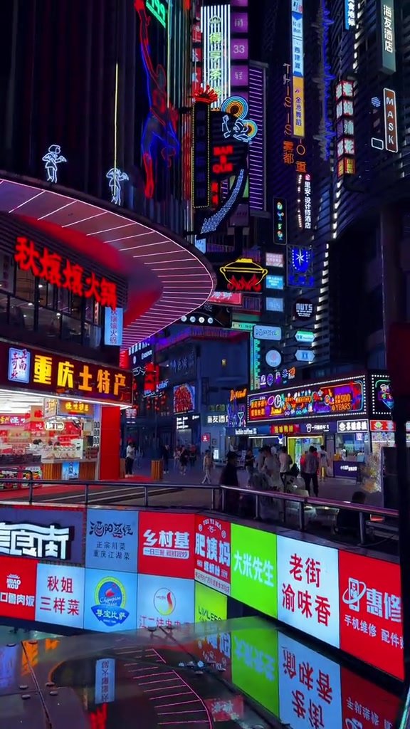 Multiple levels of illuminated walkways and shop signs in central Chongqing