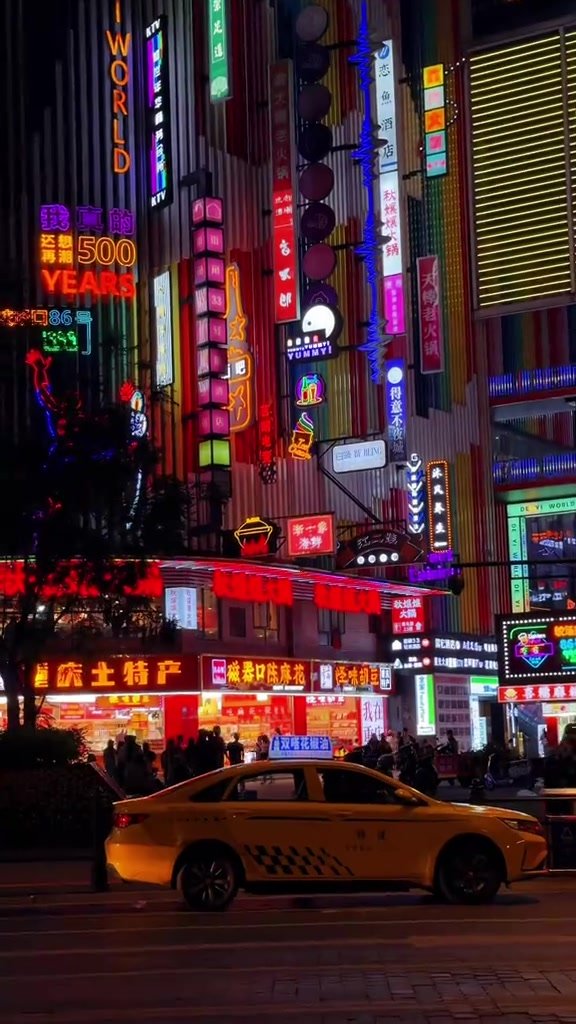 A taxi passing beneath dense neon signs in Chongqing at night