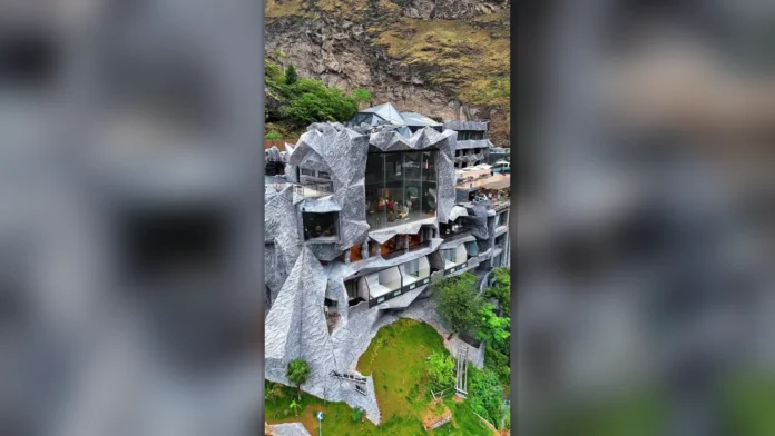 MoYe Snow Mountain Cliff Hotel built into a rocky mountainside in Yunnan, China