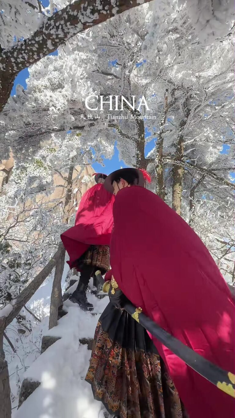 A traditionally dressed guard in the snowy forest at Tianzhu Mountain