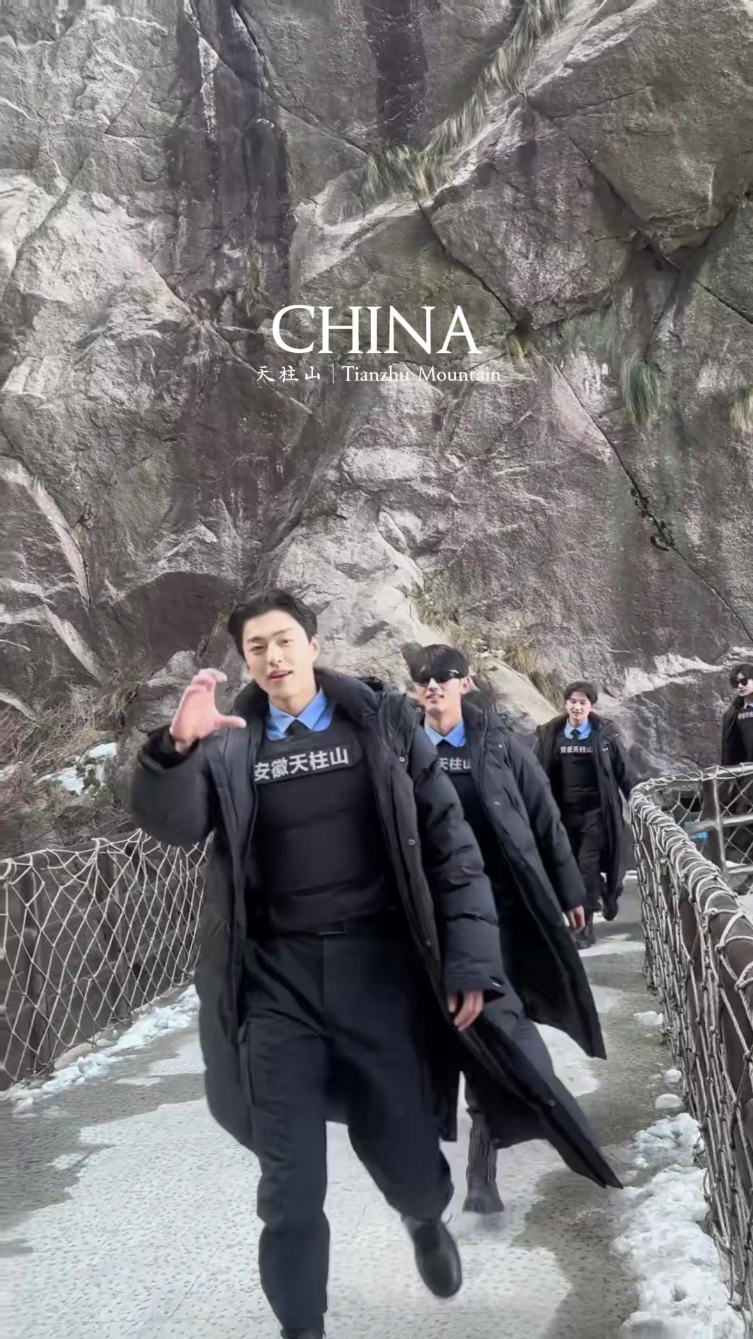 Tianzhu Mountain security staff walking along a dramatic rock wall