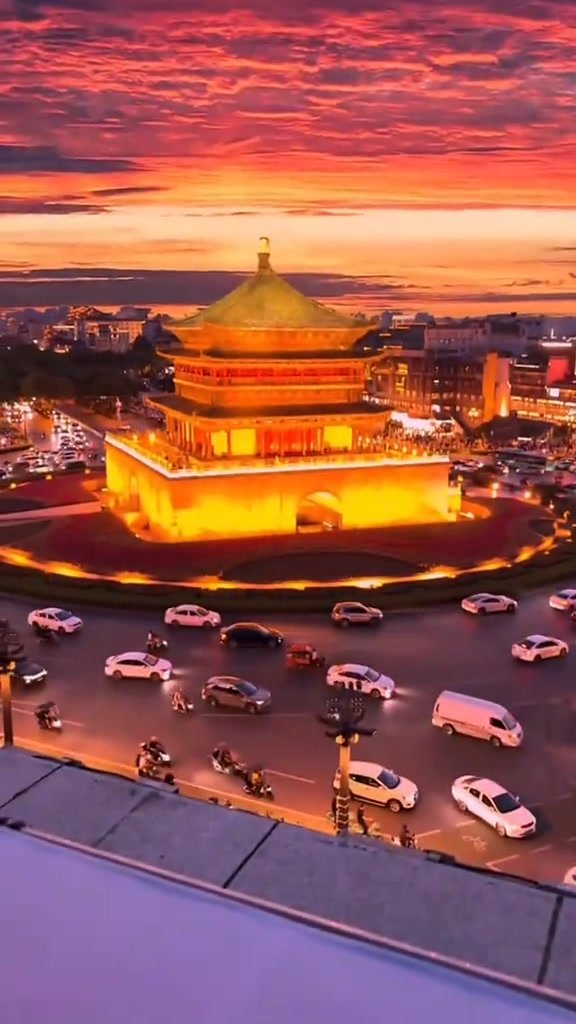 An illuminated traditional tower on Xi’an City Wall at dusk