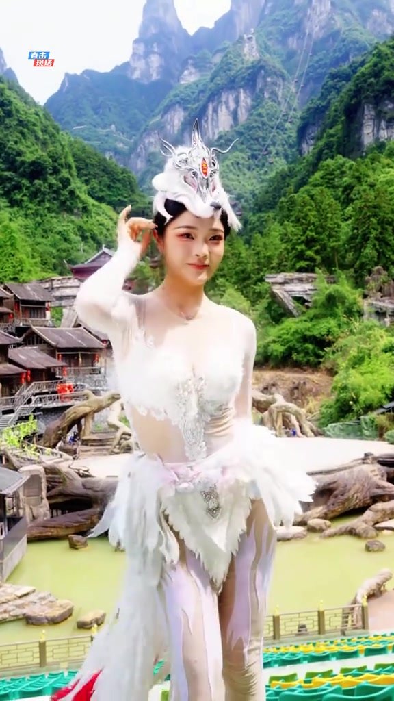 Performer framed by dense forest and the high limestone cliffs of Tianmen Mountain
