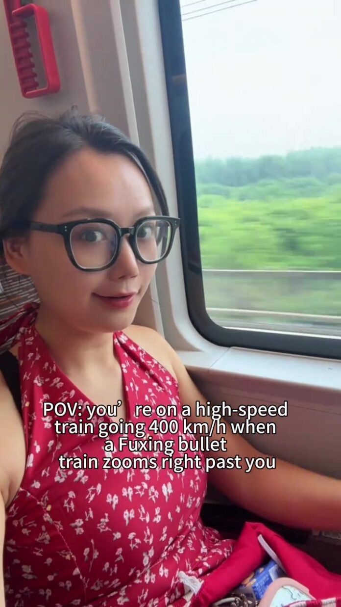 Traveler sitting beside the window aboard a high-speed train in China